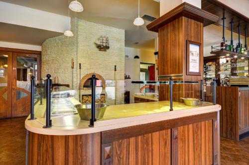 a kitchen with a counter top with a stove at Hotel Pizzeria Istria in Velké Losiny
