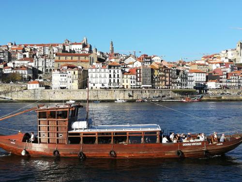 a boat in the water with a city in the background at Near the Airport in Moreira