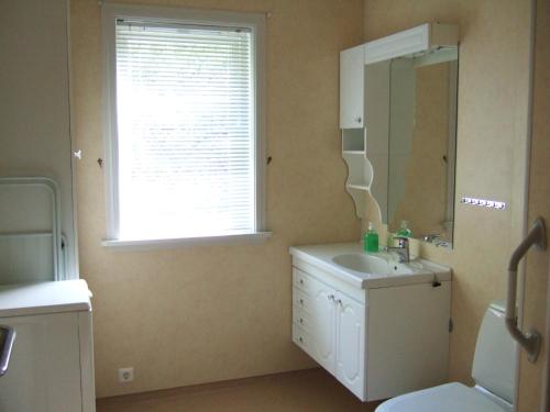 a bathroom with a sink and a mirror and a window at Flåm Holiday House in Flåm