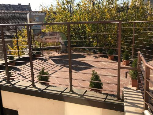 a balcony with potted plants and a railing at Art 'Otel in Sofia