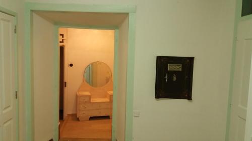 a hallway with a bathroom with a mirror and a sink at Casa de Marvila in Santarém