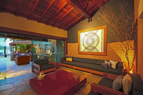 a living room with a couch and a table at Bravo Pousada Design in Cabo Frio