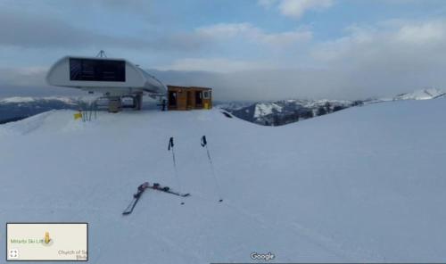 a ski lift on top of a snow covered mountain at David APT on Bakuriani Orbi Palace in Bakuriani