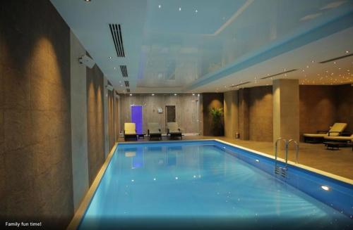 a large swimming pool in a hotel room at David APT on Bakuriani Orbi Palace in Bakuriani