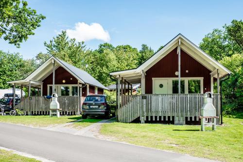 a house with a car parked in front of it at Dragsö Camping & Stugby in Karlskrona