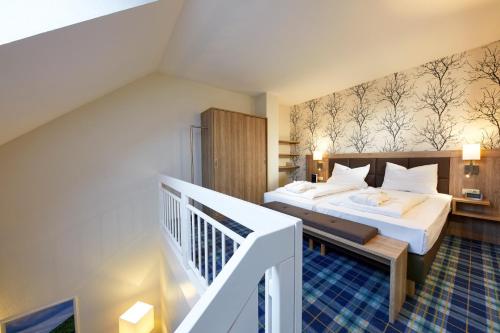 a hotel room with a bed and a staircase at Göbel's Seehotel Diemelsee in Diemelsee