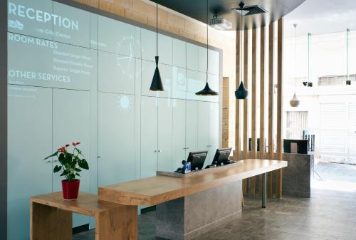 a reception desk with two laptop computers on it at ibis Jerusalem city Center - An AccorHotels Brand in Jerusalem