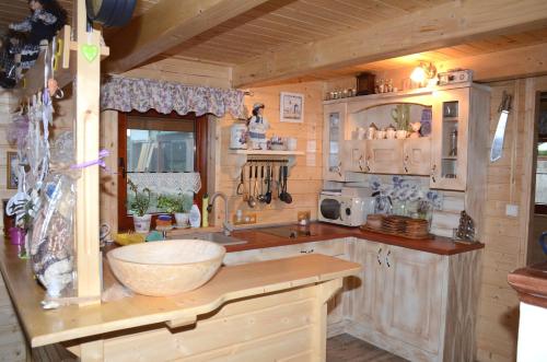a kitchen in a log cabin with a sink at Chata Emka in Vyšný Kubín