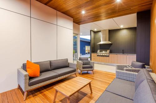 a living room with a couch and a kitchen at The Villas in Waikerie