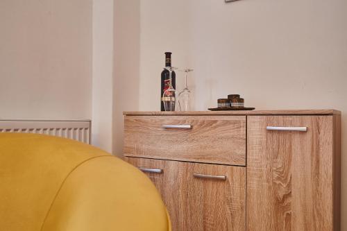 a bottle of wine on top of a wooden cabinet at Penzión Music in Nižný Slavkov