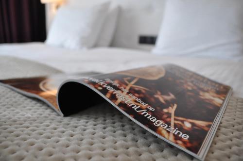 a book sitting on top of a bed at Van der Valk Hotel De Molenhoek-Nijmegen in Molenhoek