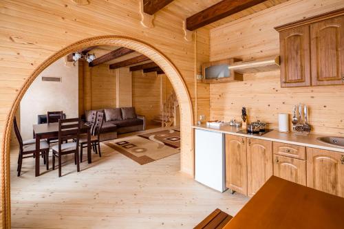 an open kitchen and dining room in a log cabin at Family Hotel Kaskad in Bukovel
