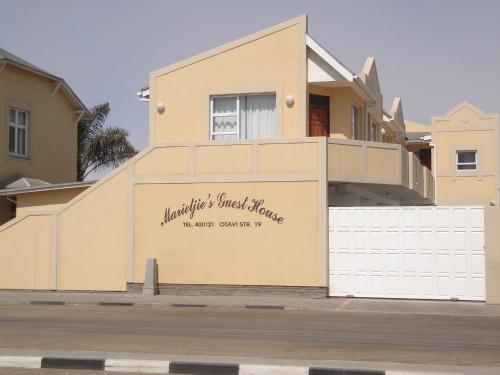 a house with a sign on the side of it at Marietjie's Guesthouse in Swakopmund