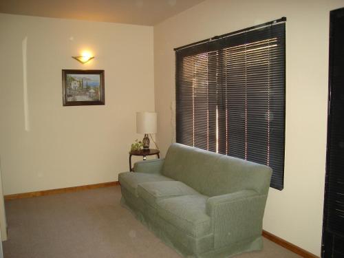 a living room with a couch and a window at Hotel Patagonia Norte in Las Grutas
