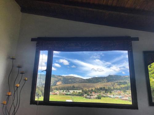 a window with a view of a mountain view at Hostal Casa Lantana in Suesca