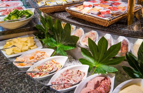 a buffet of different types of food on a table at Sachsenpark-Hotel in Leipzig