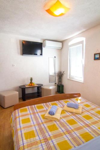 a bedroom with a bed with two towels on it at Split Inn Apartments in Split