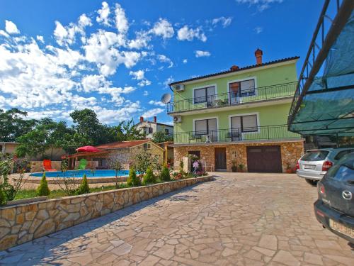 a large house with a swimming pool in front of it at Apartments Ivanka 1056 in Pula