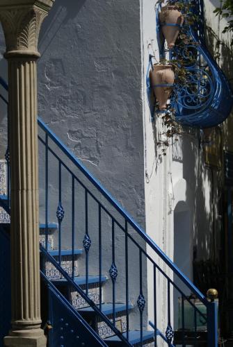 a blue stair railing next to a building at El Mouradi Mahdia in Mahdia