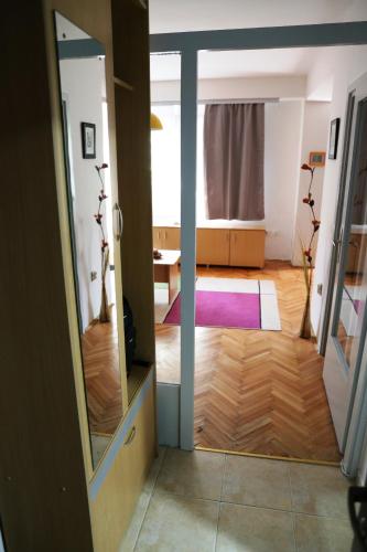 un corridoio con uno specchio e una stanza con un tavolo di Supercozy Studio a Skopje