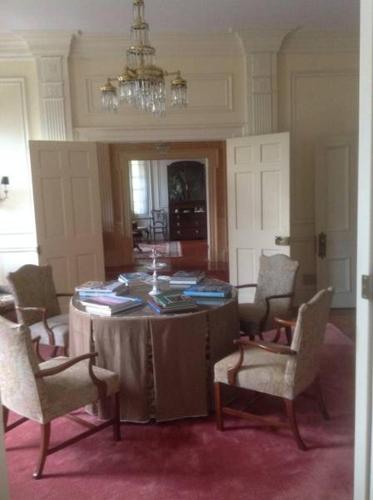 a dining room with a table with chairs and a chandelier at Springwood Inn in Anniston