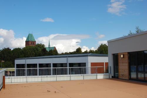 a building with a fence in front of it at Jugendherberge Ratzeburg am See in Ratzeburg