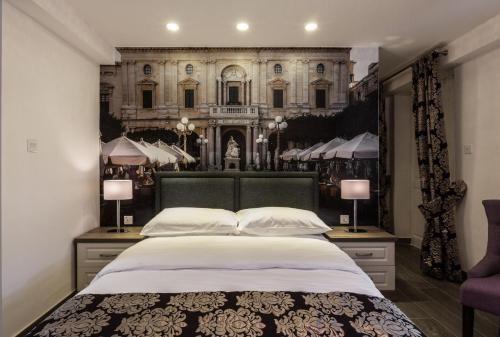 a bedroom with a large bed in front of a building at Jean de Valette Boutique Living in Valletta
