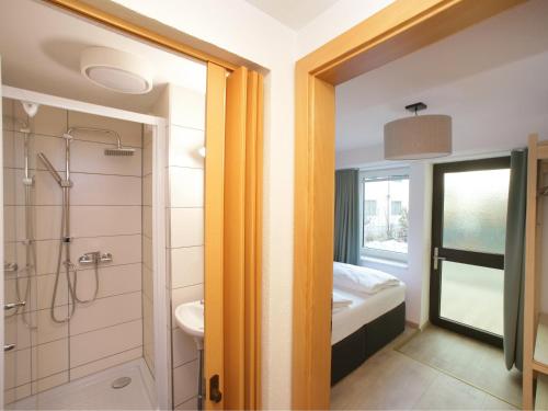 a bathroom with a shower and a toilet and a sink at Zellermoos in Zell am See