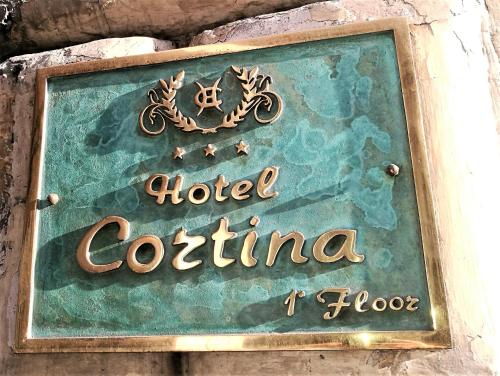 a sign for a hotel colorectinia on a wall at Hotel Cortina in Rome