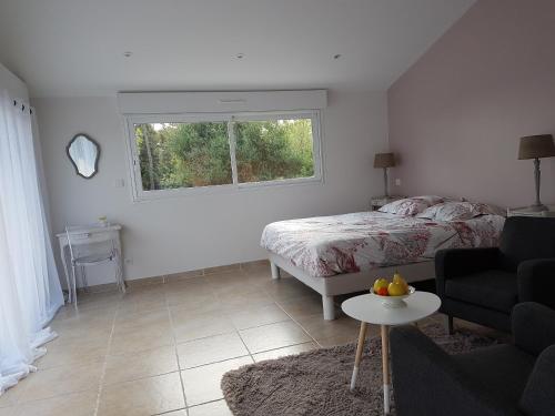 a bedroom with a bed and a window and a table at Séjour Pic Saint Loup in Saint-Mathieu-de-Tréviers