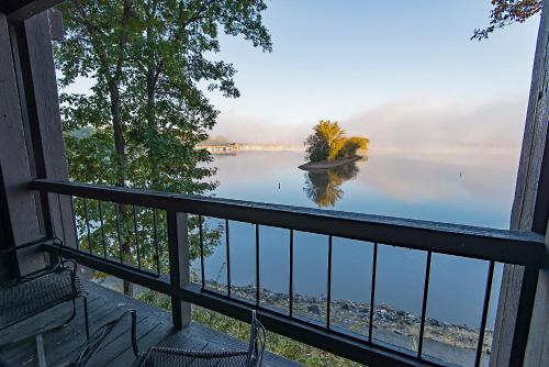 a view of a lake from a balcony of a house at Lake Barkley State Resort Park in Cadiz