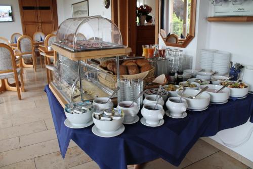 a table with a blue table cloth with bowls and cups at Hotel Windthorst in Münster
