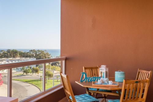 
a table with a chair and a cup of coffee at Beautiful Apartment Litoralmar in Portimão
