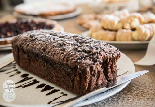 a piece of chocolate cake on a plate on a table at Palazzo Guglielmo in Vignacastrisi