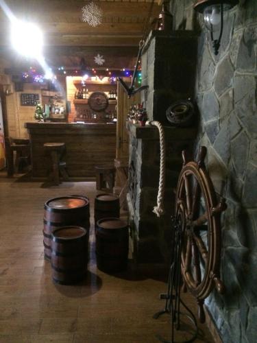 a room with barrels and a room with a bar at Laguna in Slavske
