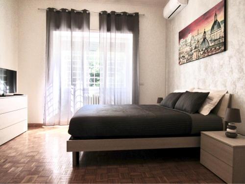 a bedroom with a bed and a large window at Roema Guest House in Rome