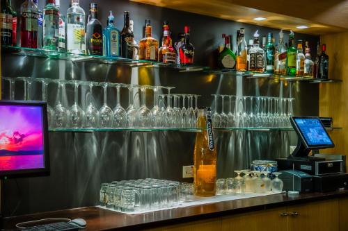 a bar with a lot of glasses on the wall at Parkhotel Auberge Vincent in Nuenen