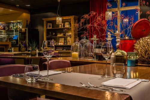 a table in a restaurant with wine glasses on it at Parkhotel Auberge Vincent in Nuenen