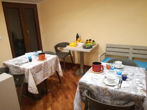 two tables with plates and cups on top of them at Fonte Nuova Penne in Penne