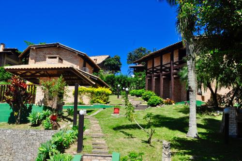 a house with a garden in front of it at Pousada Albacora in Bombinhas