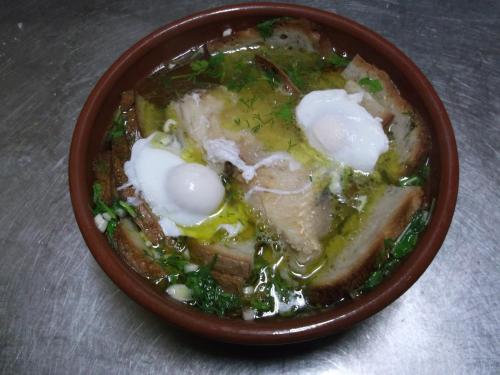 a brown bowl of food with eggs in it at Quinta do Pinheiro in Grândola