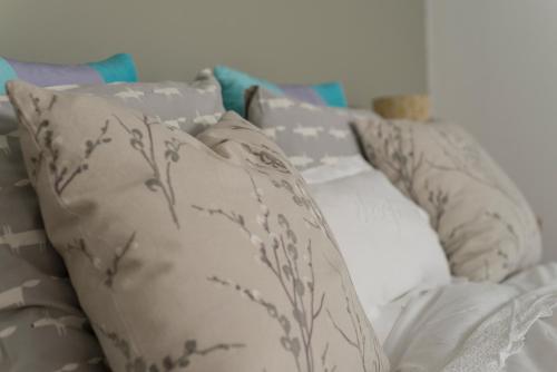 a group of pillows sitting on a couch at The Old Nurseries B & B in Stathern