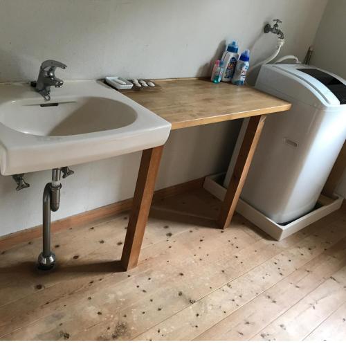 a bathroom with a sink next to a trash can at Guesthouse Irago in Tahara