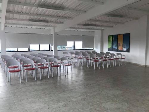 a large room with a bunch of chairs in it at Hotel Santa Monica in Fusagasuga
