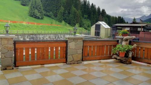 a wooden fence with a bear statue on it at Casa Andreola in Valfurva