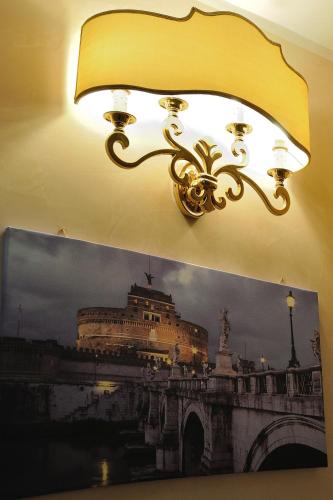 a light hanging from a wall with a picture of a bridge at Al Casaletto Hotel in Settecamini
