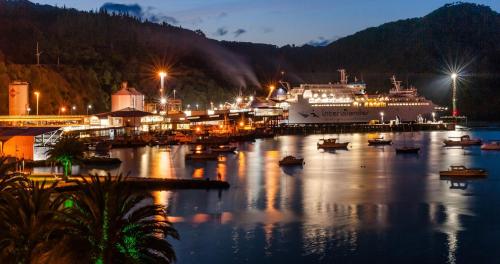 a cruise ship docked in a harbor at night at Picton Waterfront Penthouse in Picton