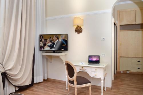 a room with a desk and a computer on a wall at Grand Hotel Vittoria in Montecatini Terme