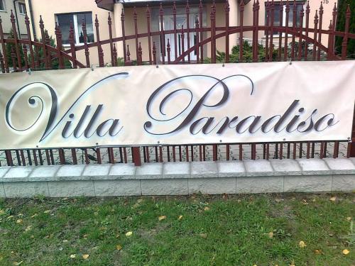 a sign that reads villa zaraza on a fence at Villa Paradiso in Wrocław