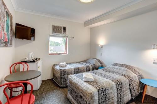 Arena Hotel (formerly Sleep Express Motel)にあるベッド